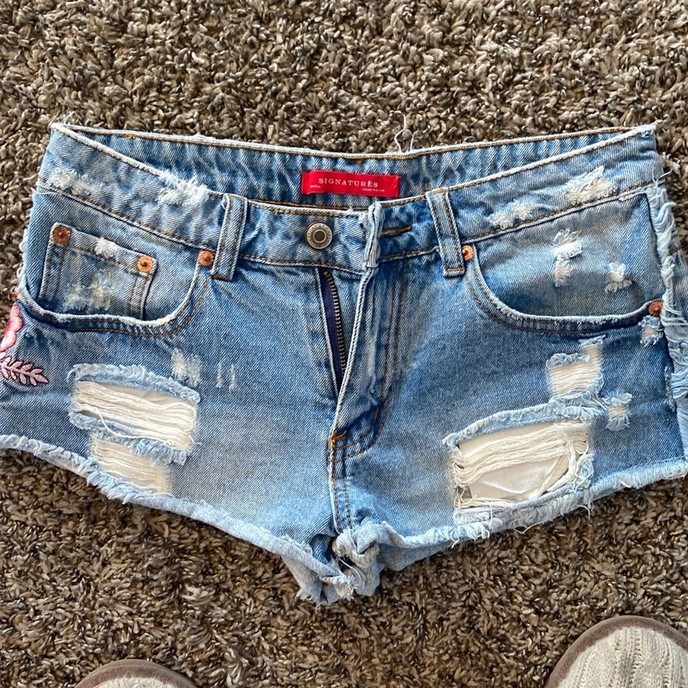 Jean cutoffs with pink flower appliqué